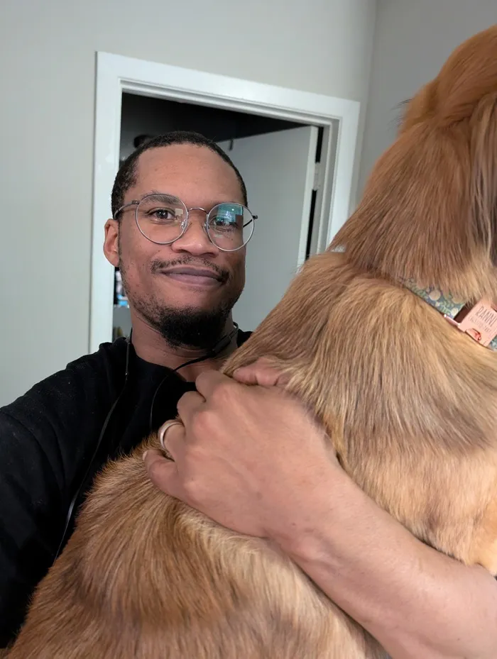 Danny holding Ranni and wearing a new pair of bronze-colored glasses
