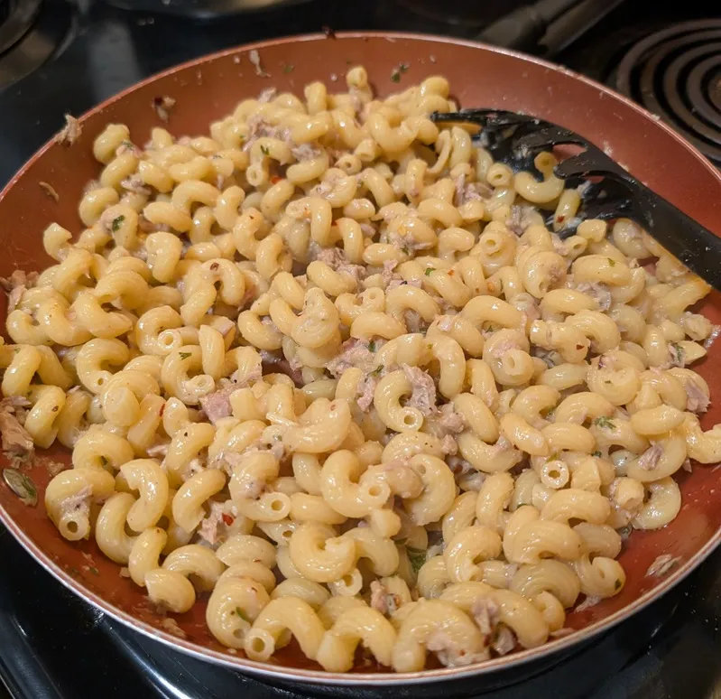 spiral pasta and tuna in a skillet with spices