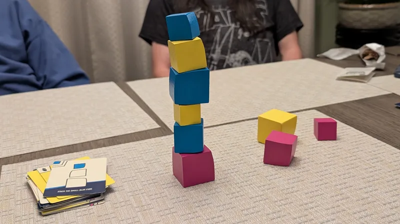 a deck of cards lying next to a tower of colorful blocks