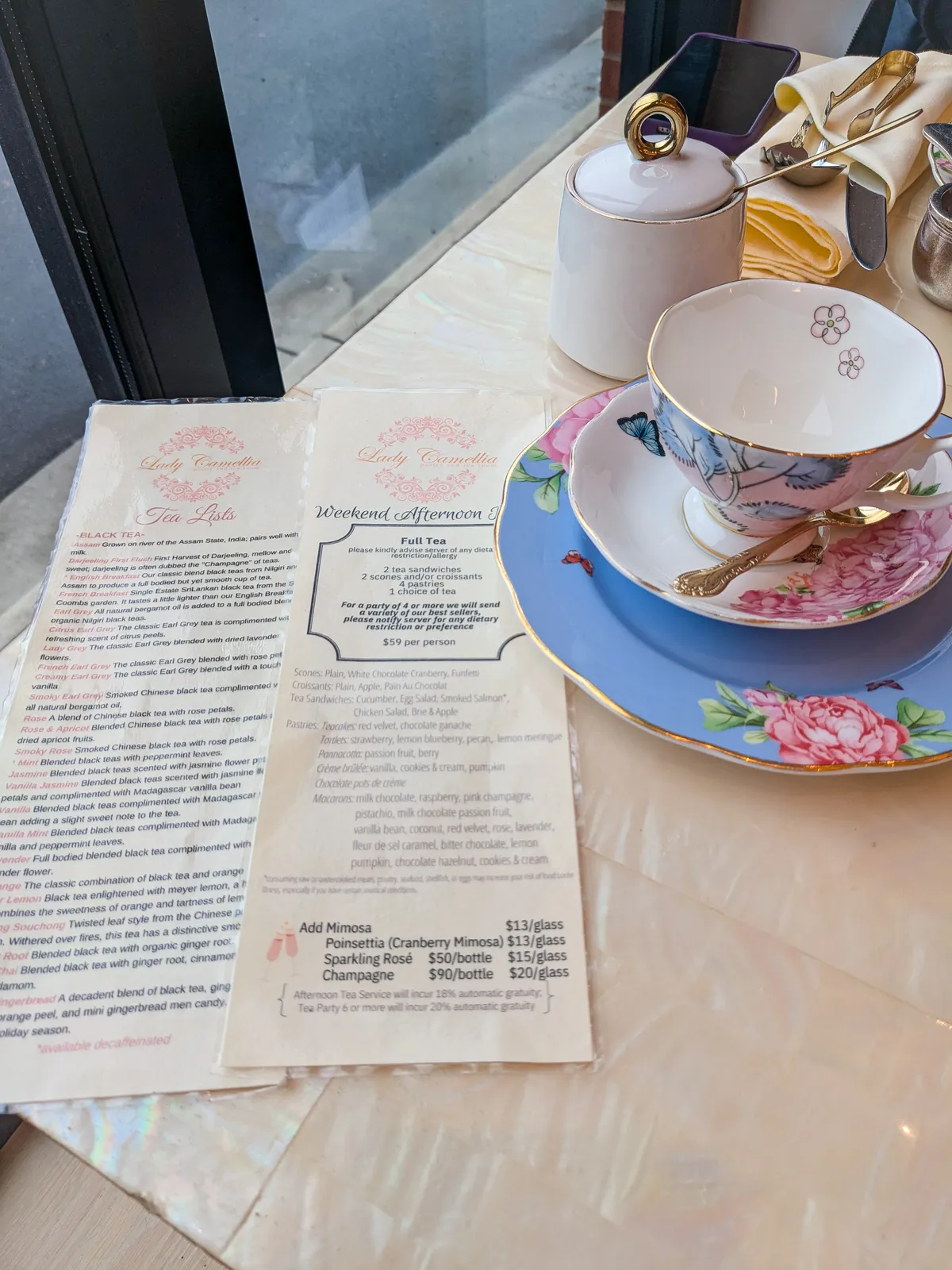 A menu for Lady Camellia and an empty floral cup