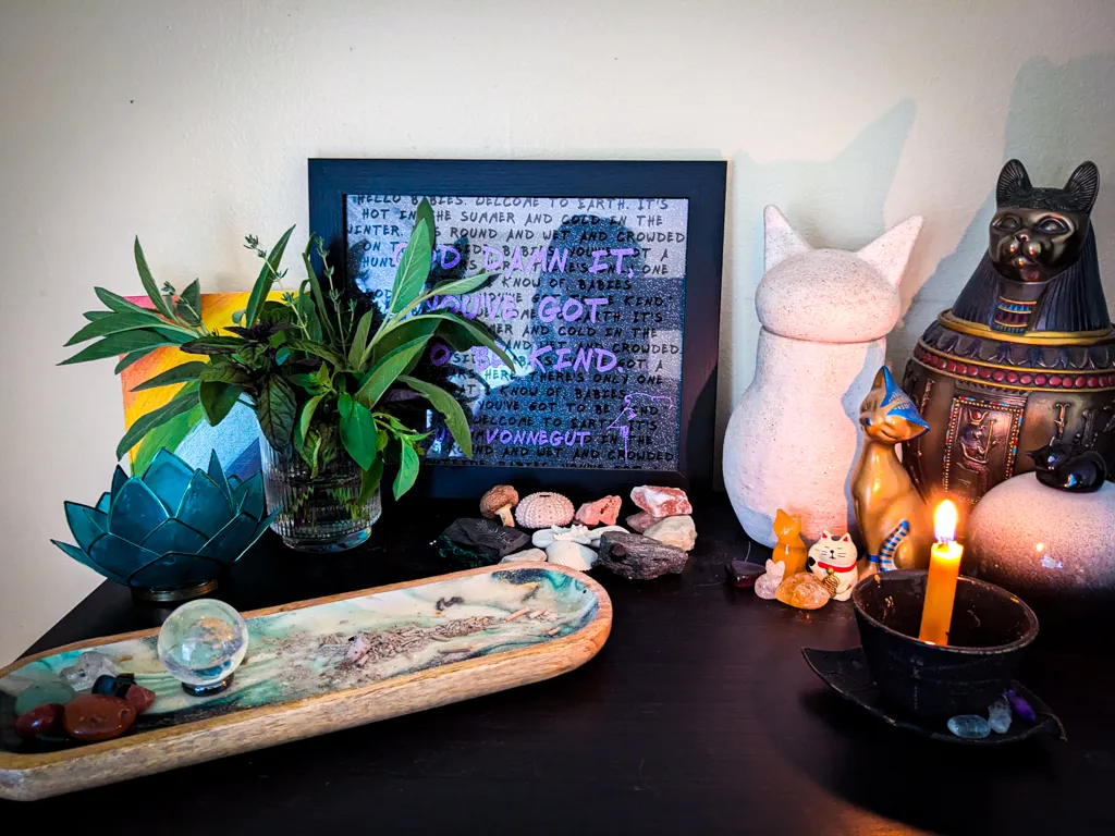 Cut herbs, rocks and shells, three cat urns, some incense and a candle