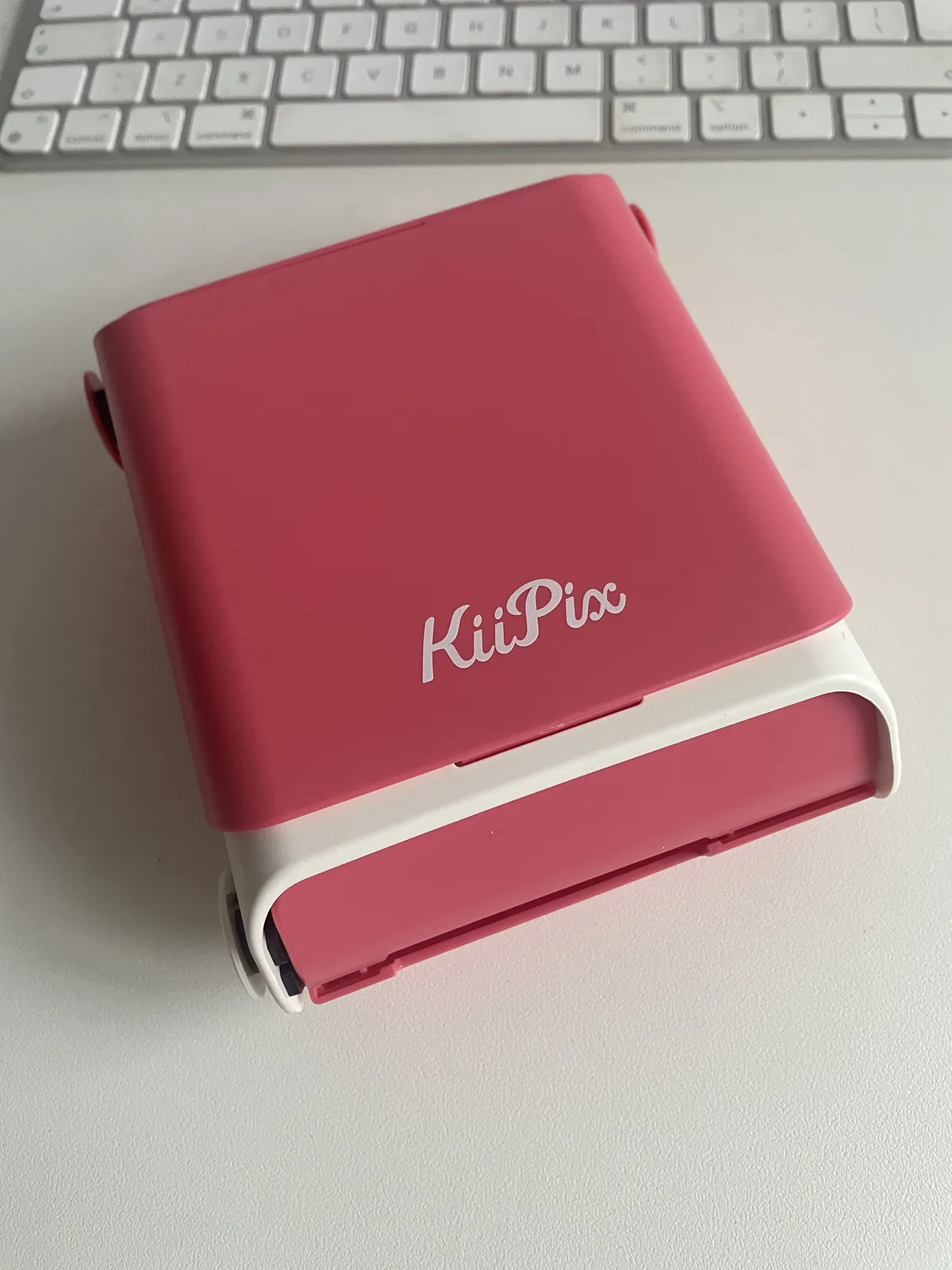 A pink Tomy KiiPix, the donor for the Instax back