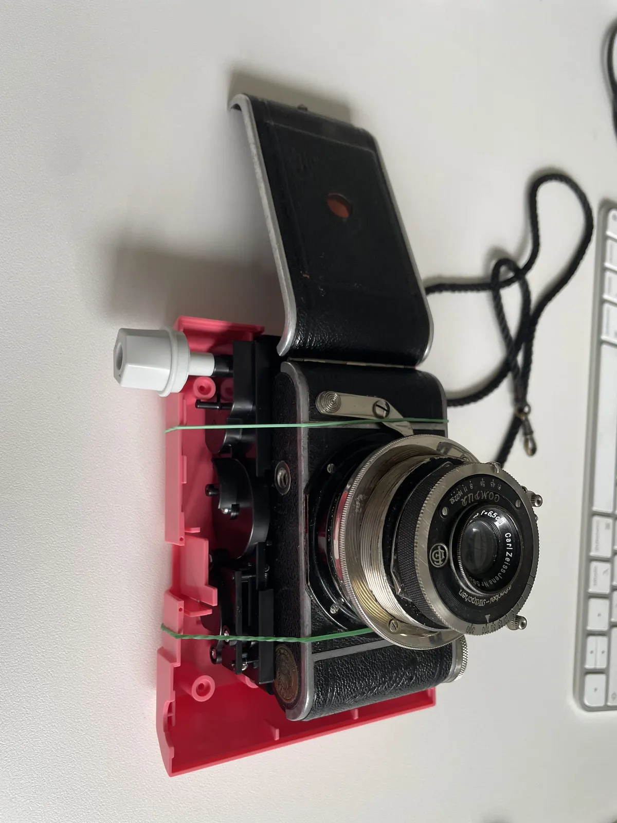 The guts of the Tomy KiiPix attached to the back of the Parvola by rubber bands