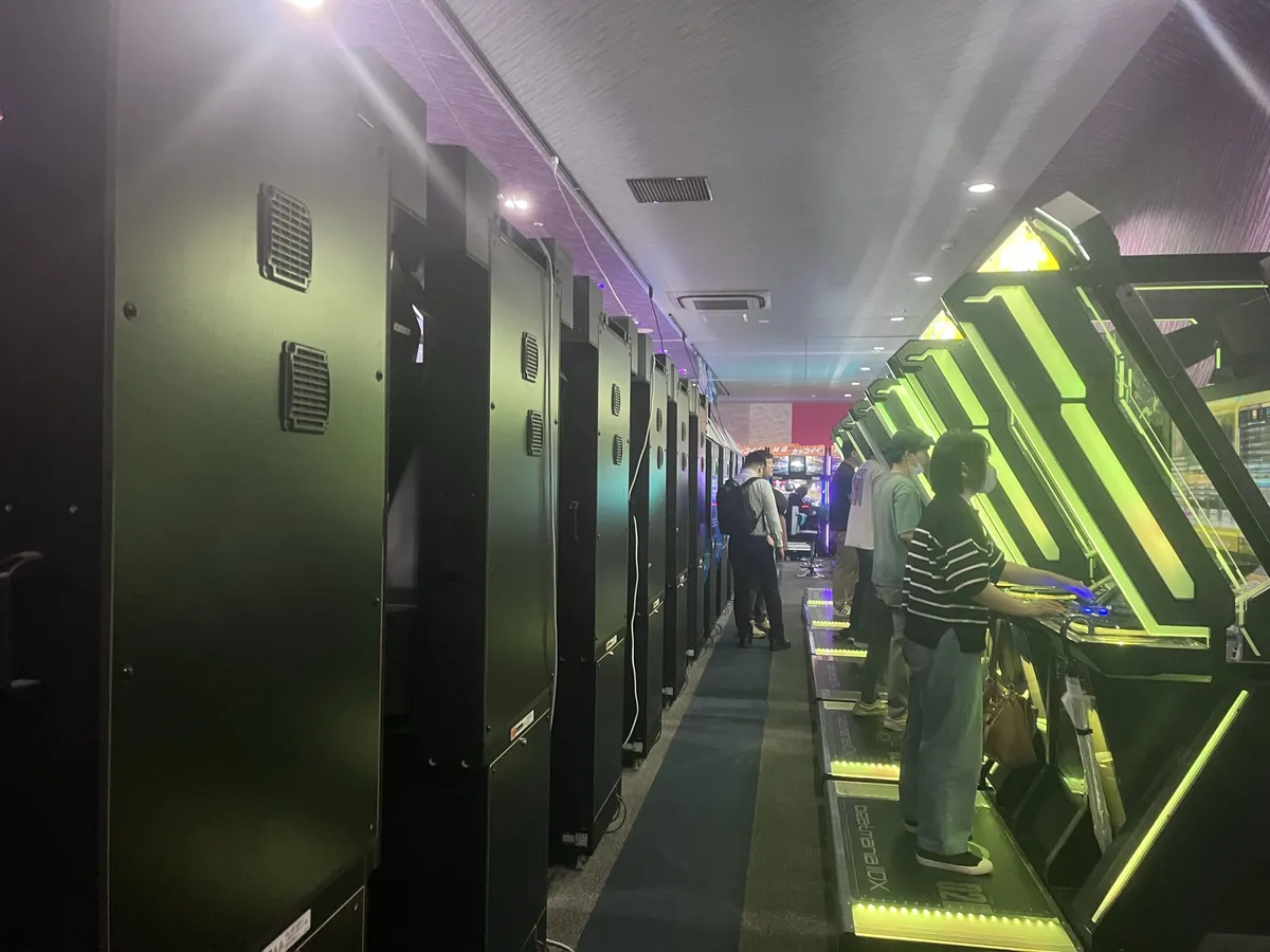 Rows and rows of the most popular music game here (Beatmania maybe?)