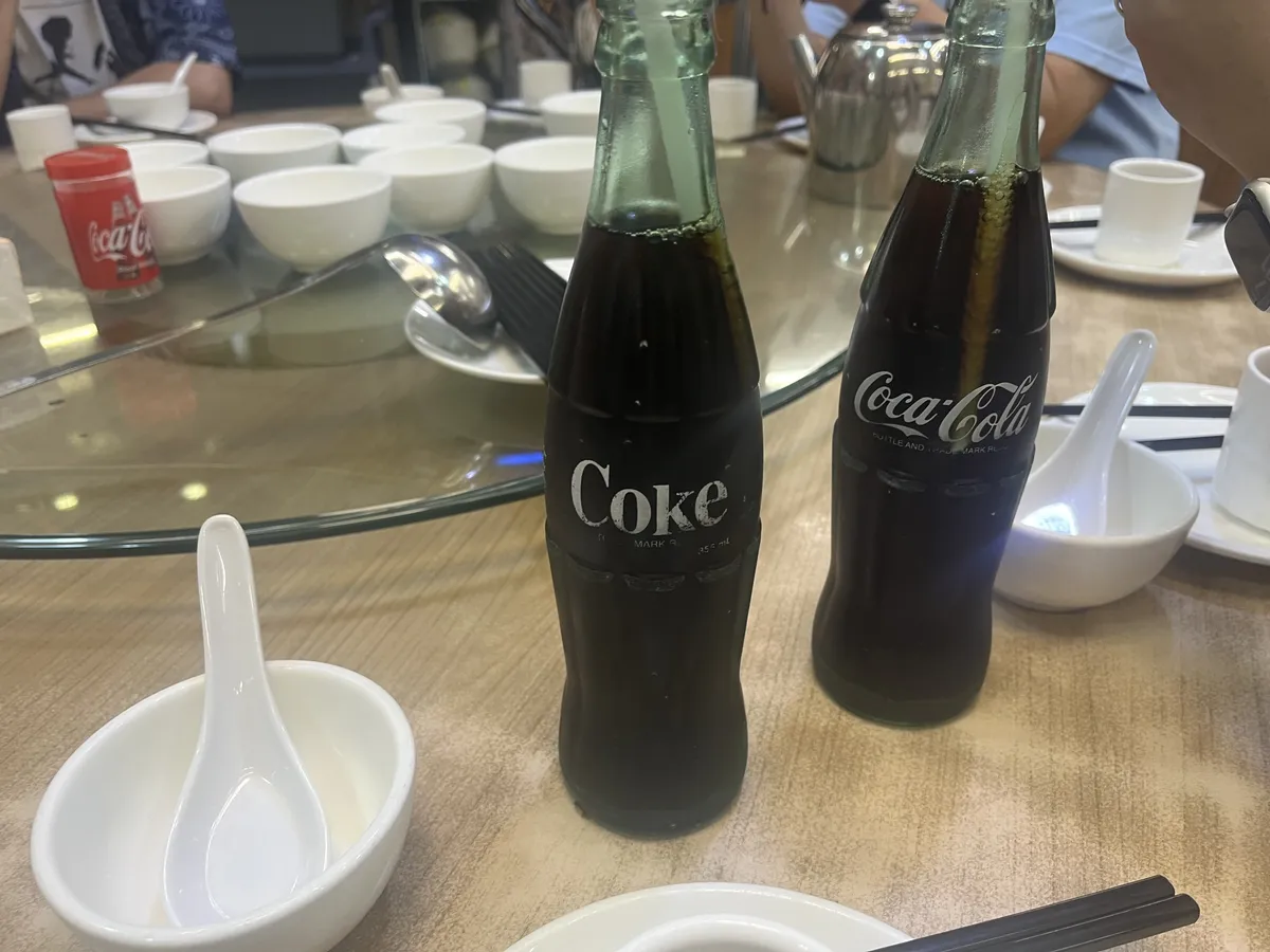 Bottled Cokes to relieve heat as we wander in. If folks recall my vlog from last year, it has a very different quality to North American Coke. A bit flatter and a bit less sweet—better for lemon Coke, and perhaps more fitting for our palette, but not as satisfying for that “cracking open a cold one” kind of hit