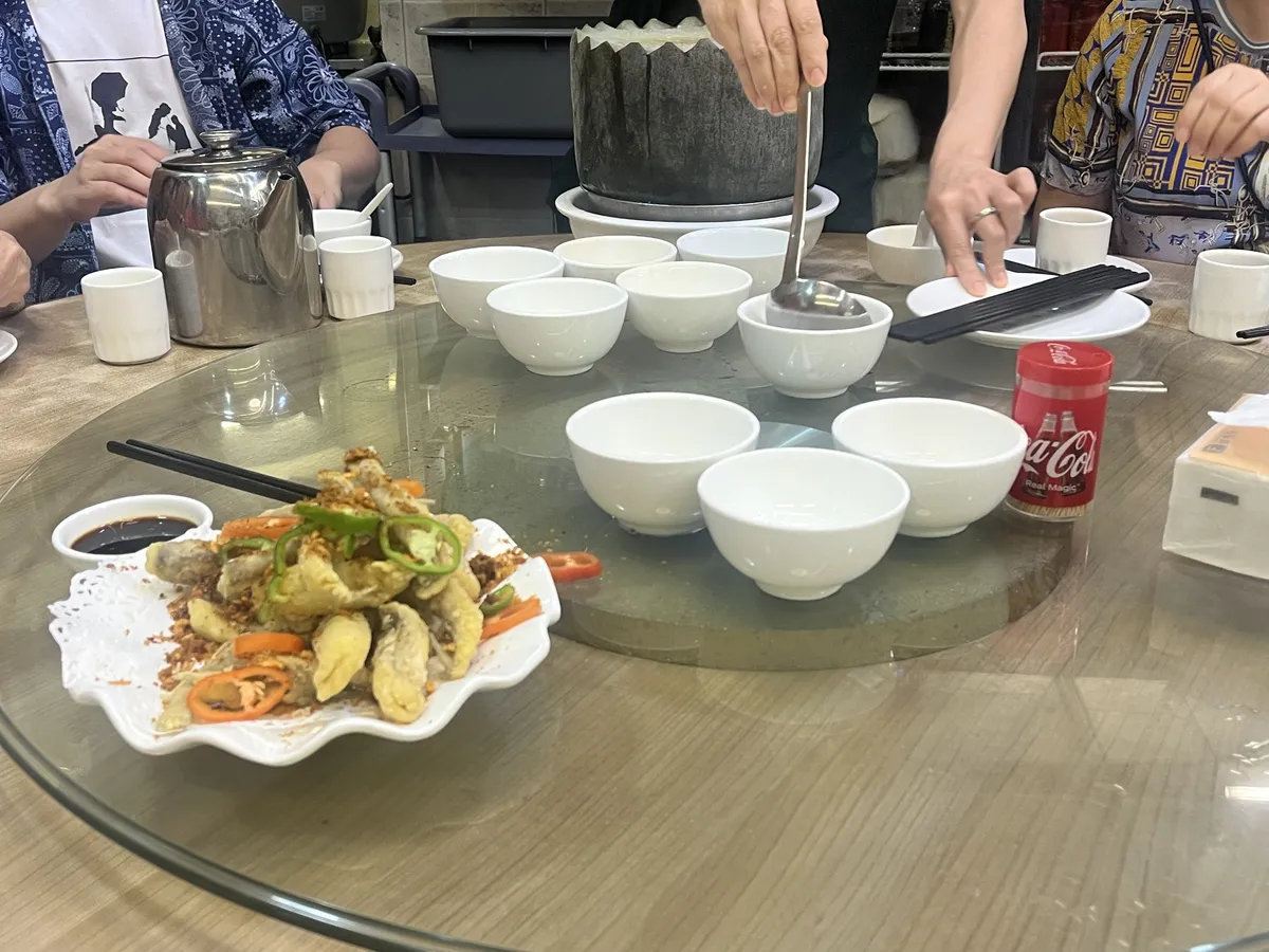 Fried fish and a winter melon soup (冬瓜盅). The soup is cooked for hours inside a massive winter melon, and while serving, the meat of the melon (which is not at all sweet and slightly umami when cooked as it absorbs the flavour of the soup over time) carved out for each bowl