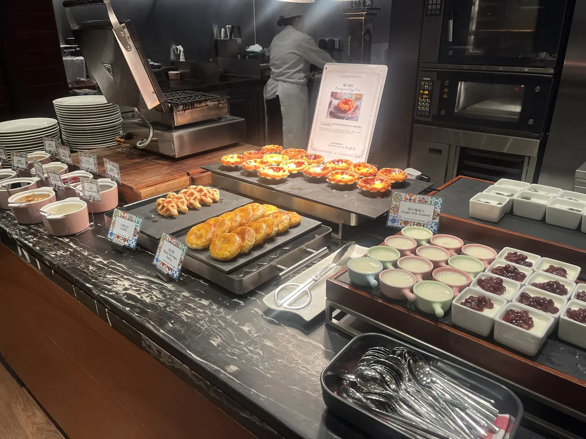 Dessert station featuring Portuguese tarts, croffles, and ginger milk puddings