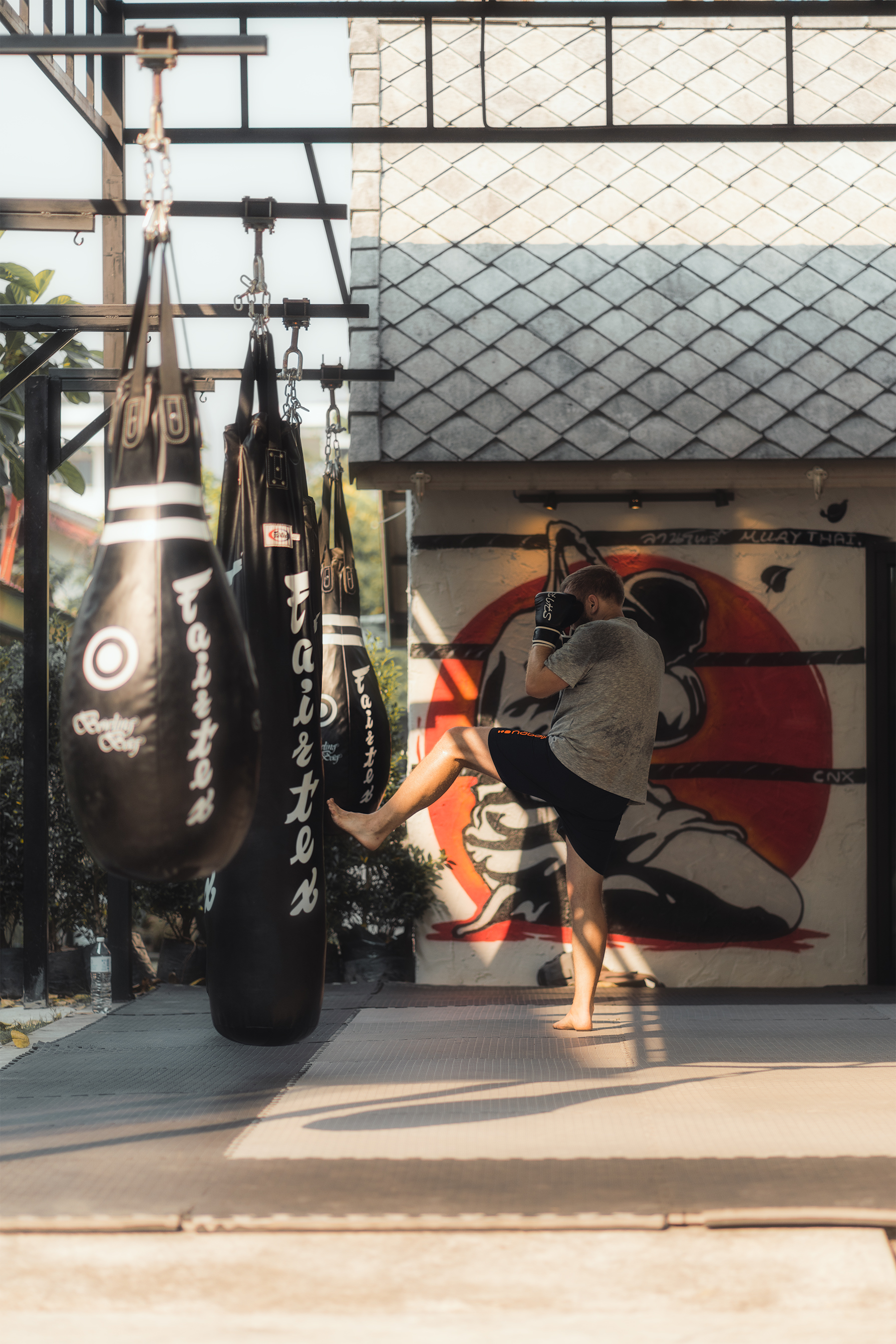 Man training with a punching bag - portrait 2