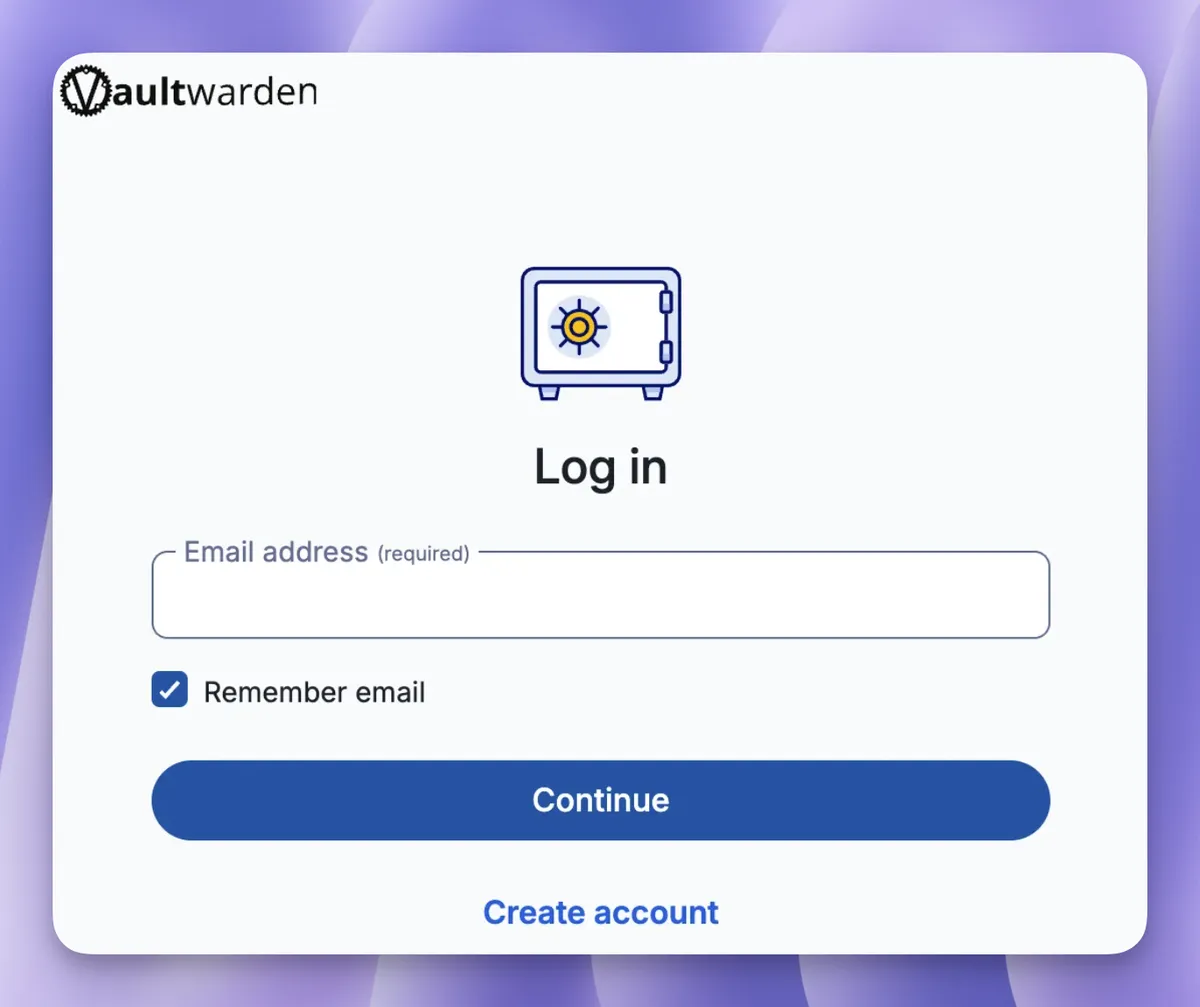 Giao diện trang đăng nhập Vaultwarden với logo Vaultwarden ở trên cùng bên trái. Ở giữa trang là hình minh họa chiếc két sắt xanh lam với núm xoay vàng. Dưới tiêu đề "Log in" là trường nhập Email address, checkbox "Remember email" đã chọn, nút "Continue" màu xanh lam, và liên kết "Create account" ở dưới cùng.