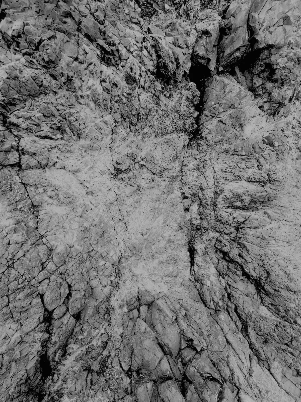 basalt cliff side with rough rocky texture in high contrast