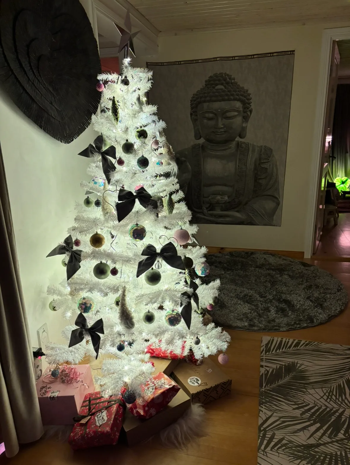 White Christmas tree with Buddha in the background