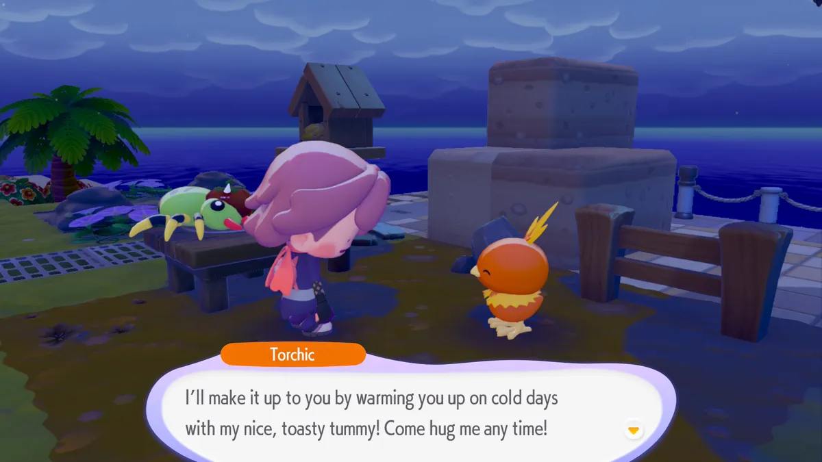 Imagem do Pokémon Pokopia, onde o Ditto, transformado em pessoa, conversa com um Torchic. Ele diz que sua barriguinha é quentinha e que você pode abraçá-lo para se aquecer no frio