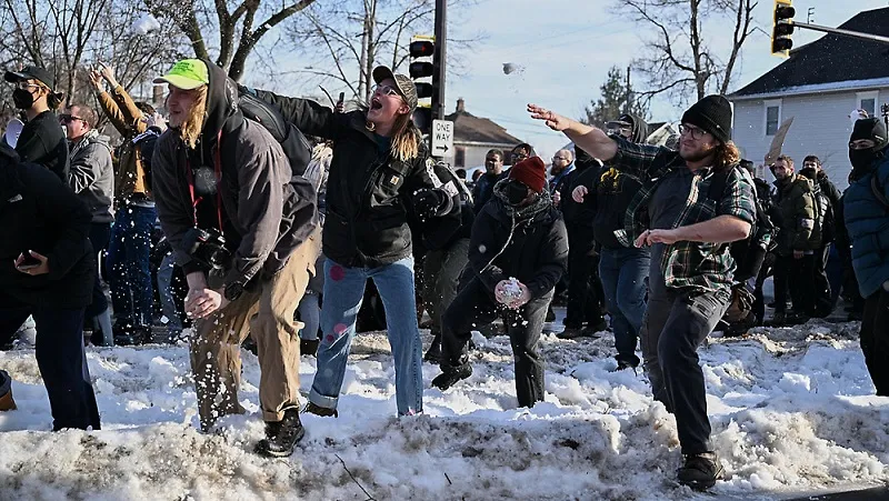 Protesters throwing snowballs at officers cleaning a murder