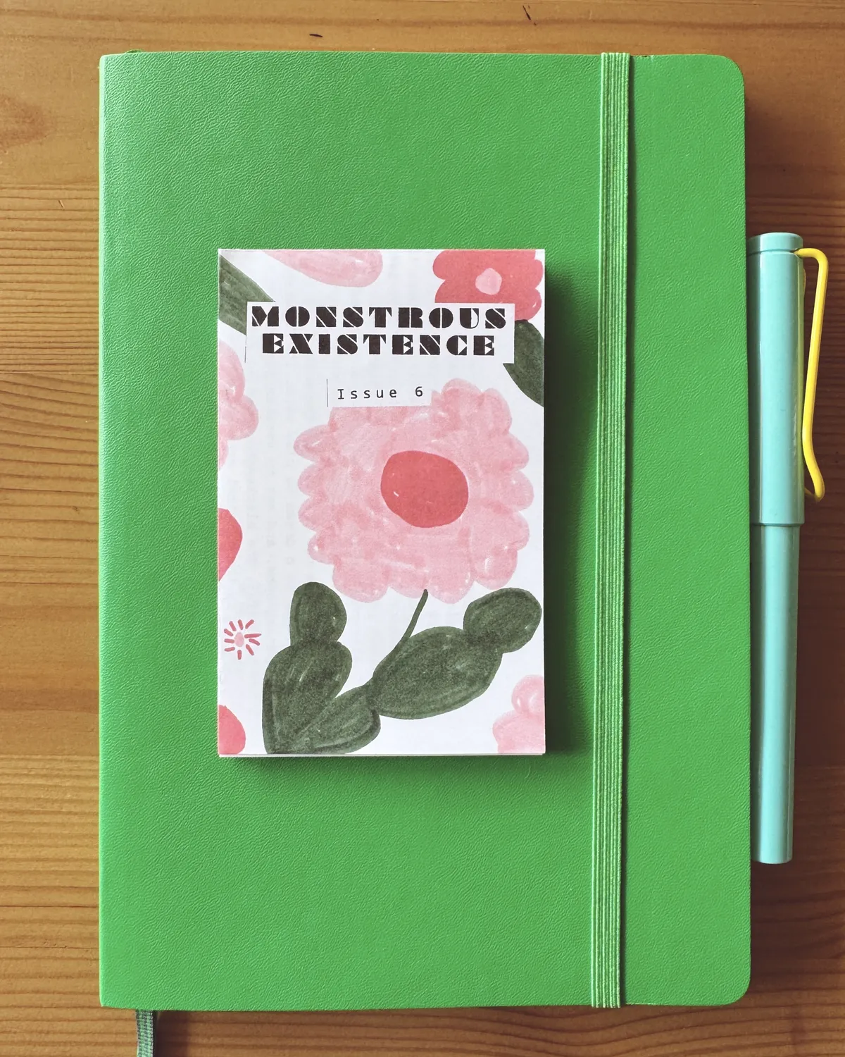 a tiny one page zine with pink flowers on the front