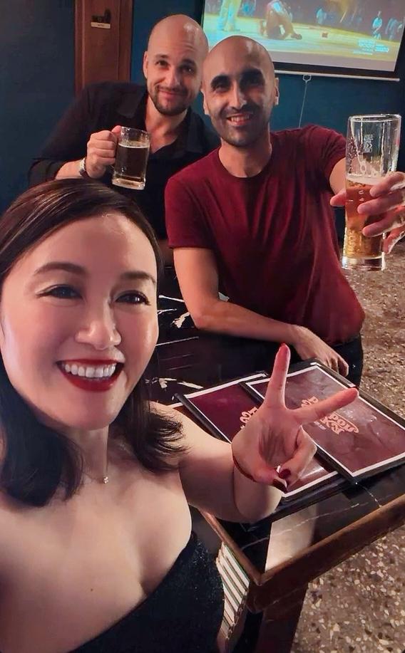 Three friends enjoying drinks at a bar