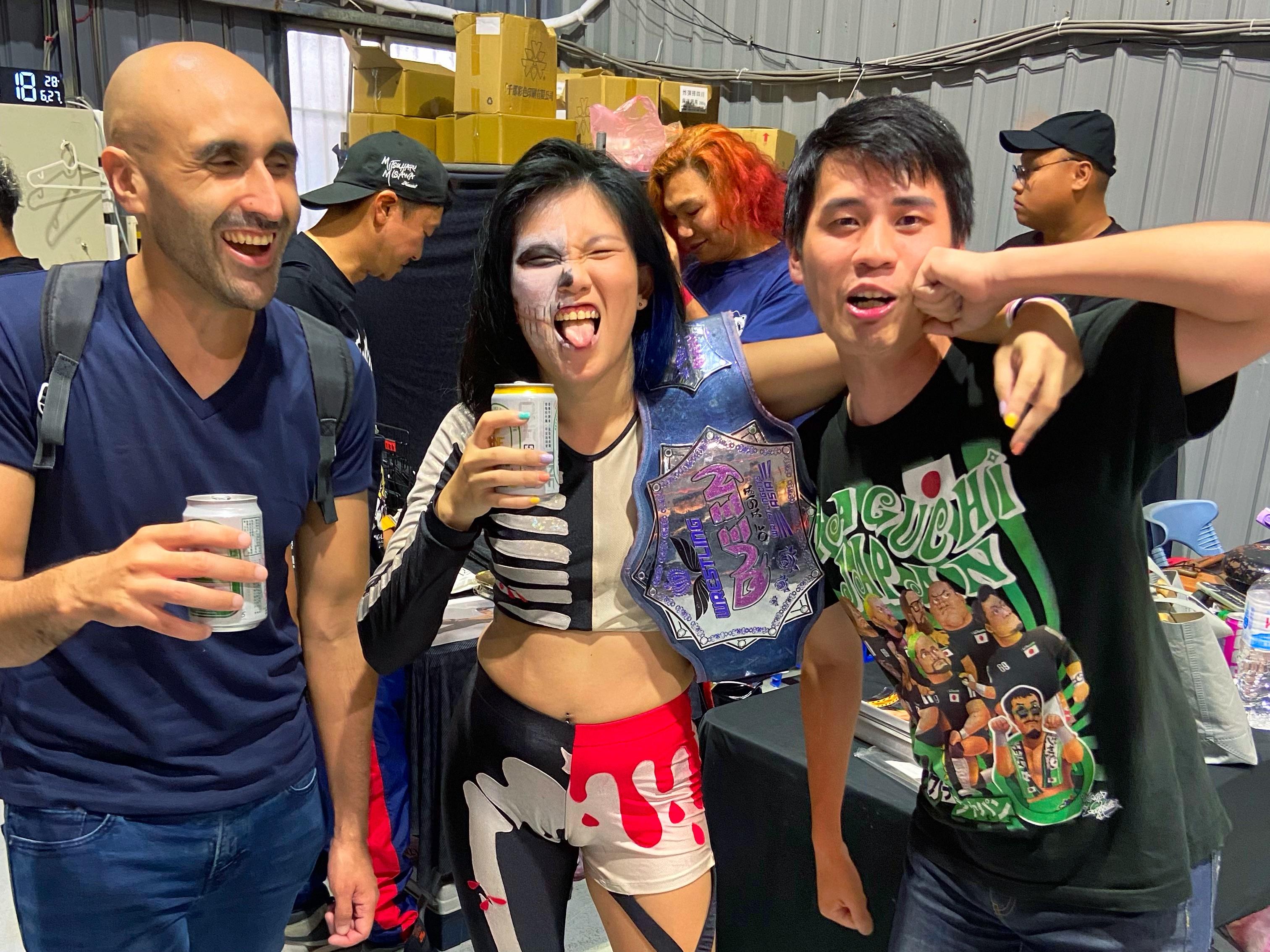 Two men post with pro-wrestler Alexis Lee