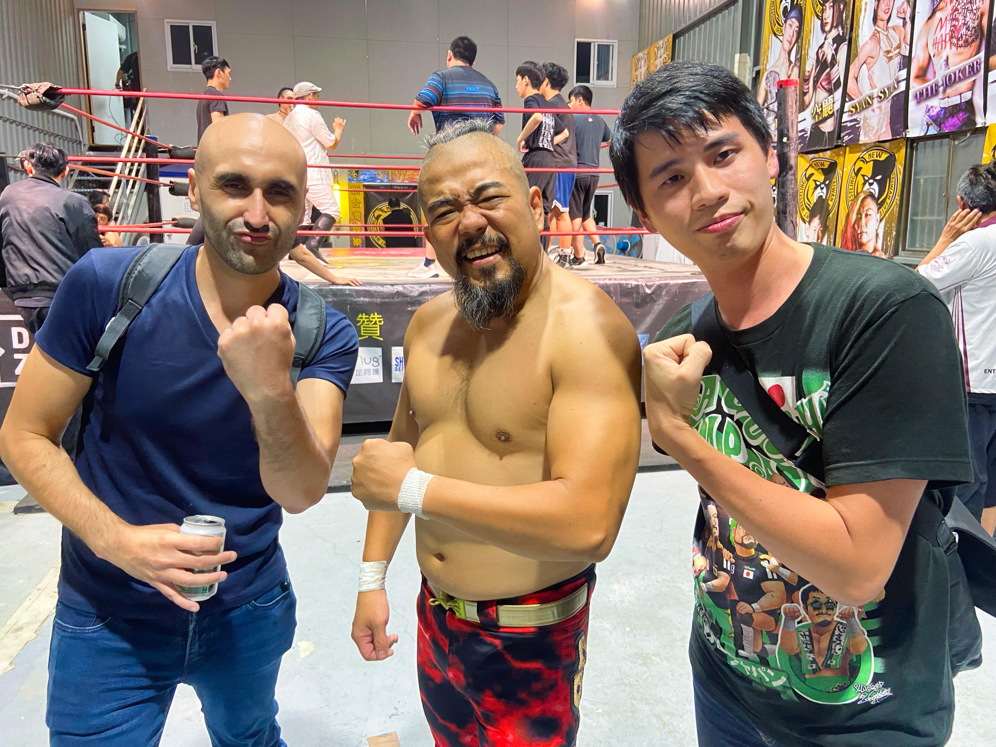 Two men post with pro-wrestler A-Yong-Go