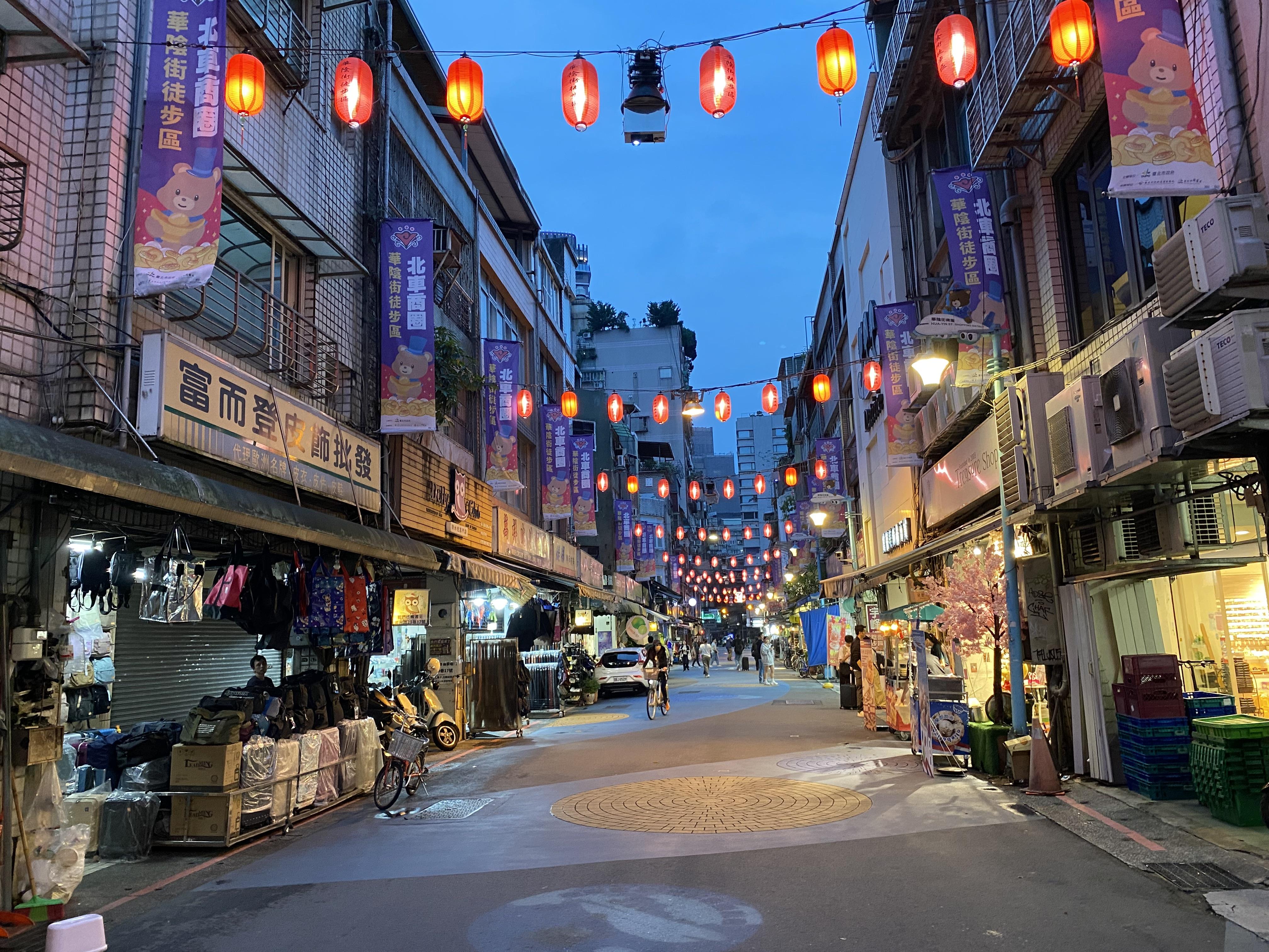 Taipei street lit up by traditional red lanterns hanging overhead