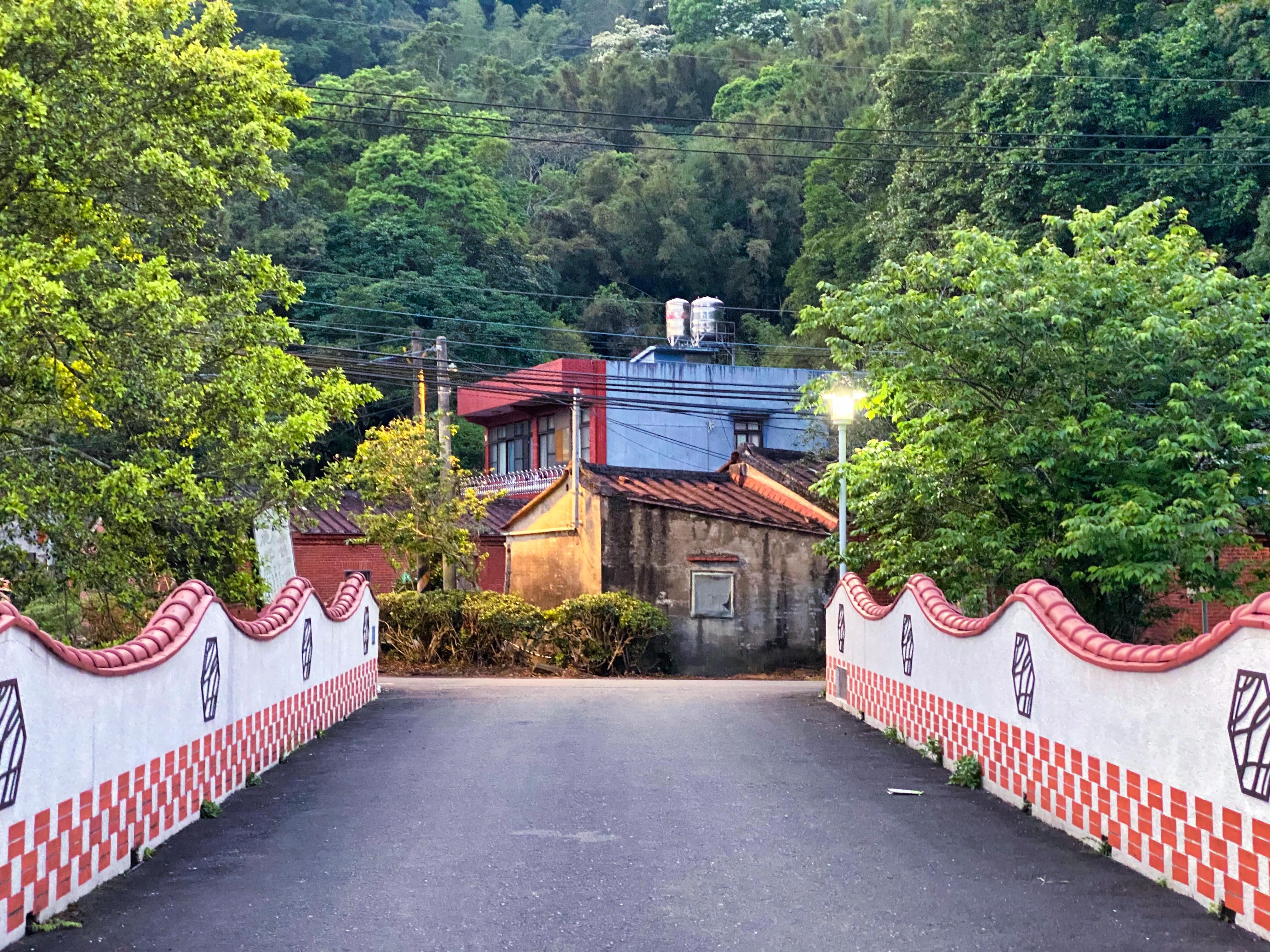 A bridge leading to an old building at dusk