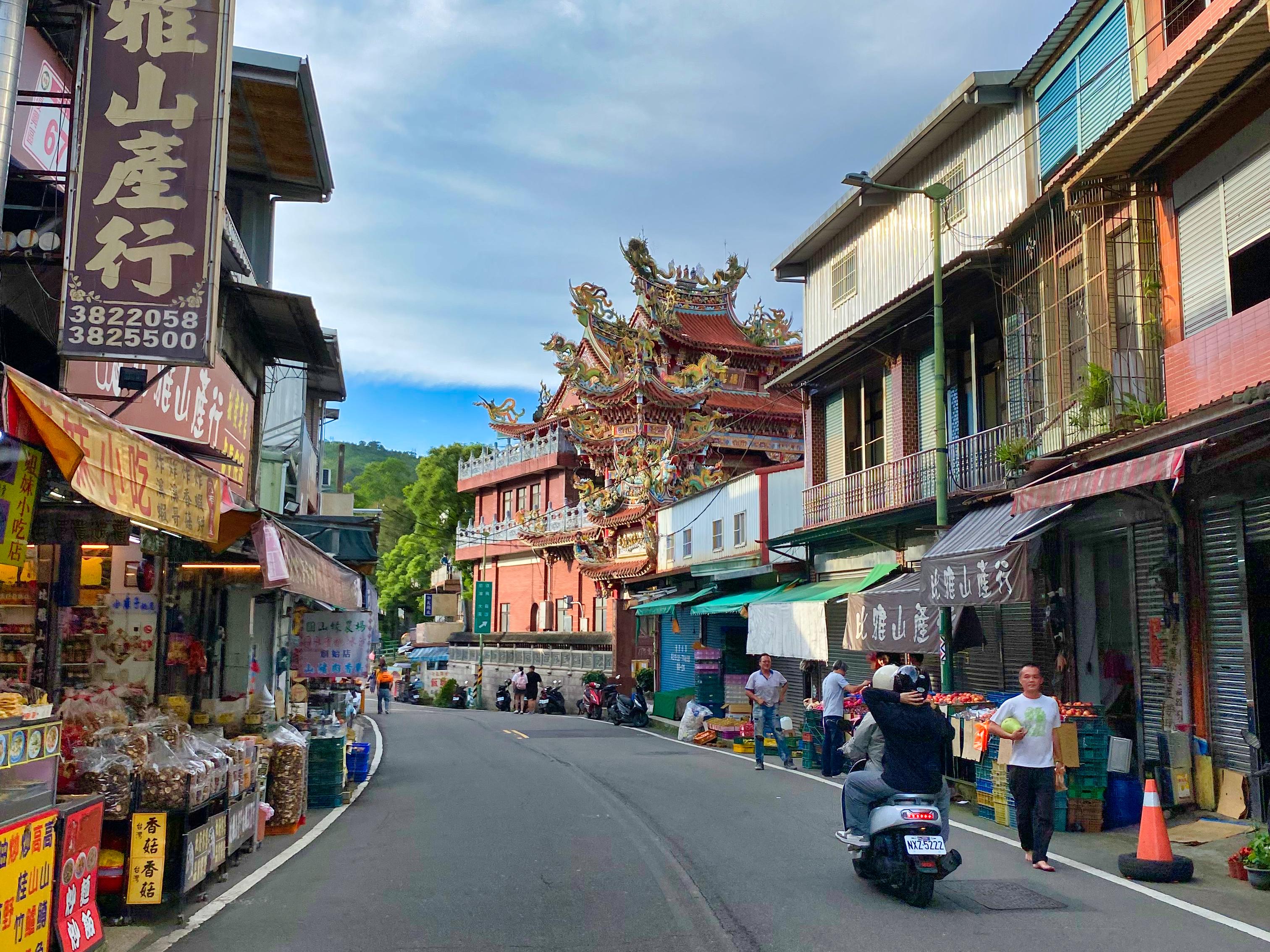 A view of the main street near Jiaobanshan Park, with focus on a temple