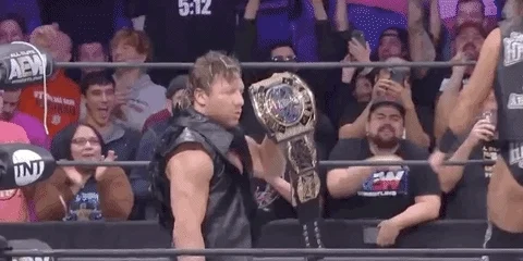 Kenny Omega posing in the in the ring