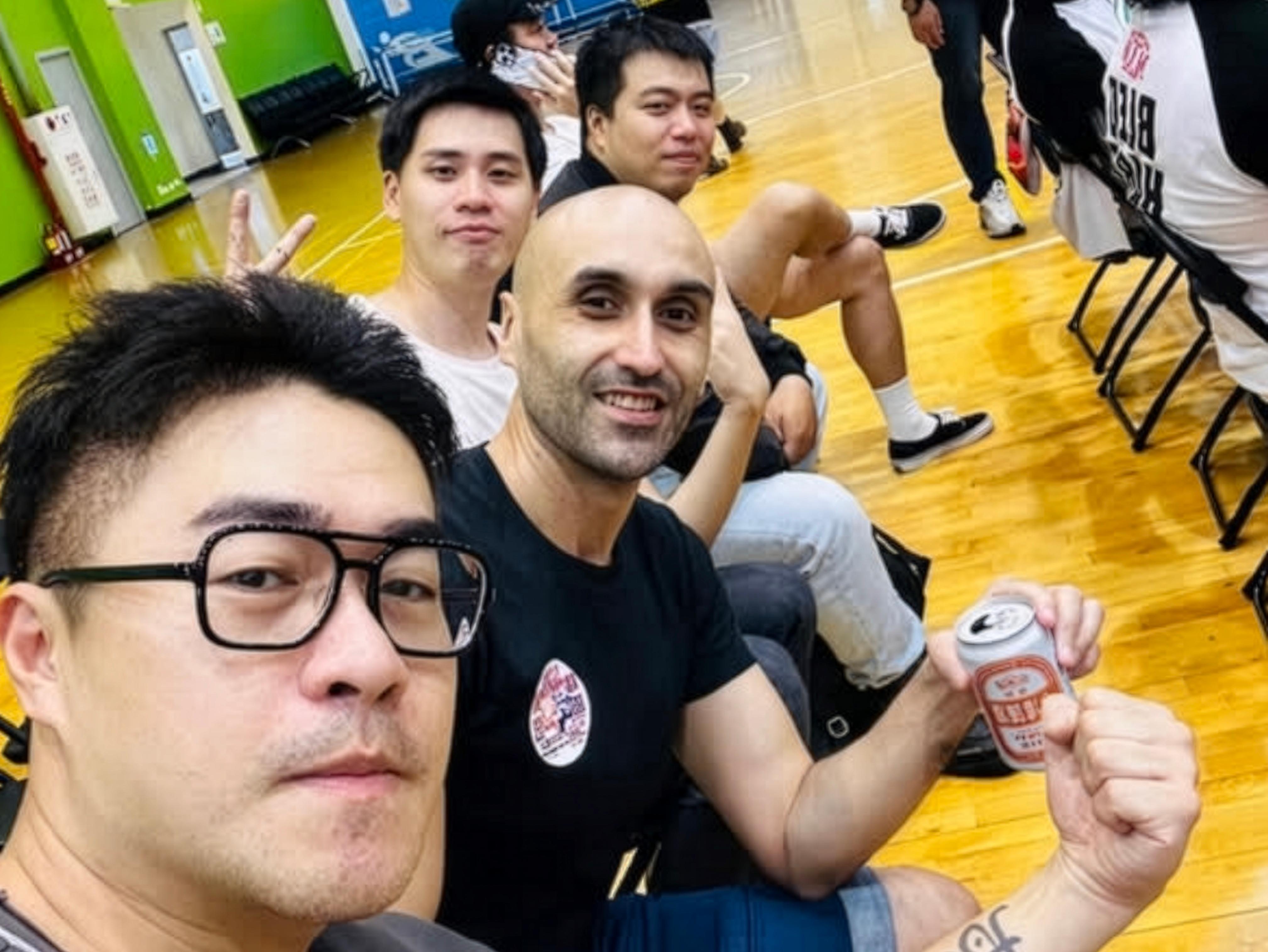 Four male friends posing for a selfie at a pro-wrestling show
