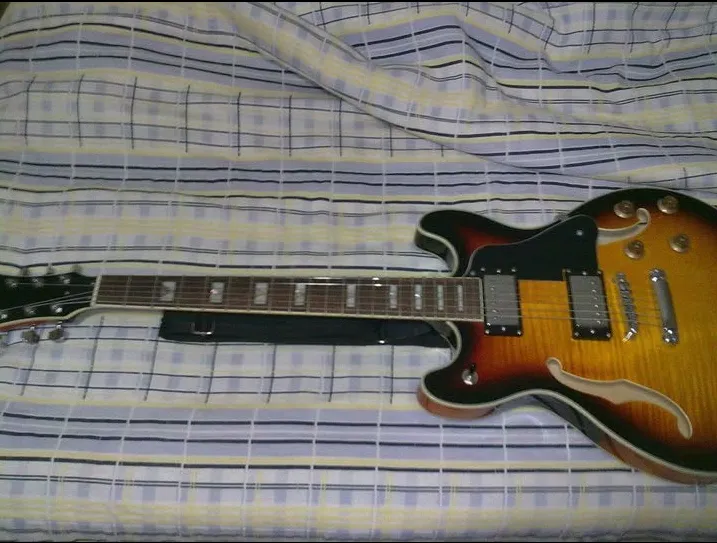 A semi-hollow guitar in sunburst color.