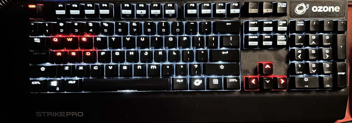 A black mechanical keyboard with white and red lighting in the keys.