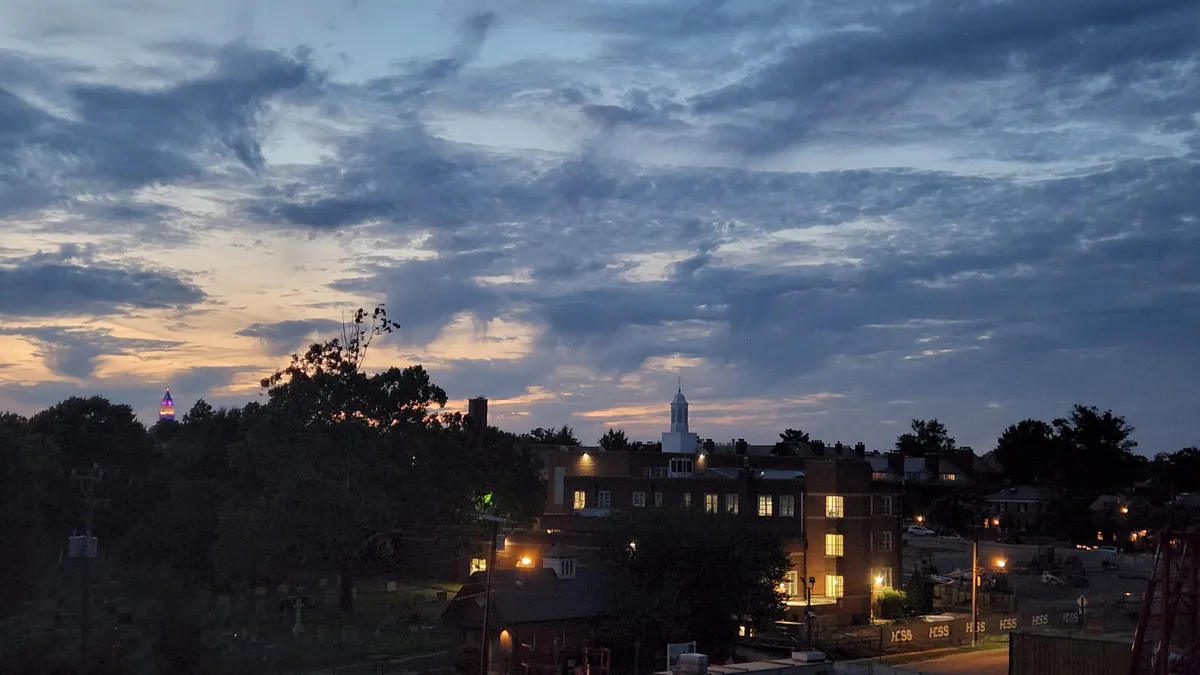 Late sunset view of Alexandria with the Masonic Temple showing in between distant trees