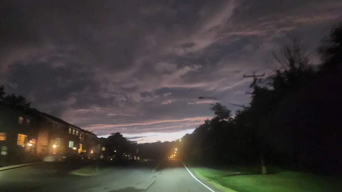 Deep purple clouds over a neighborhood at night