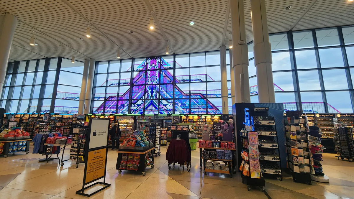 Stained glass arrow behind a gift shop at an airport