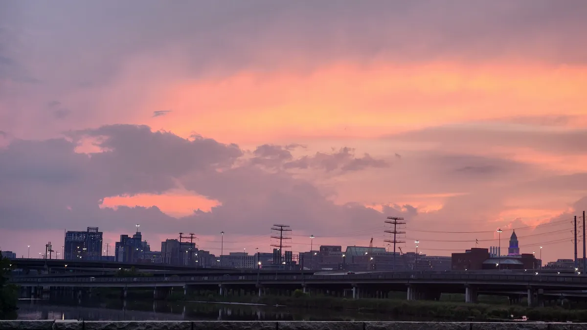 Pink and purple cloudy sunset over suburbs