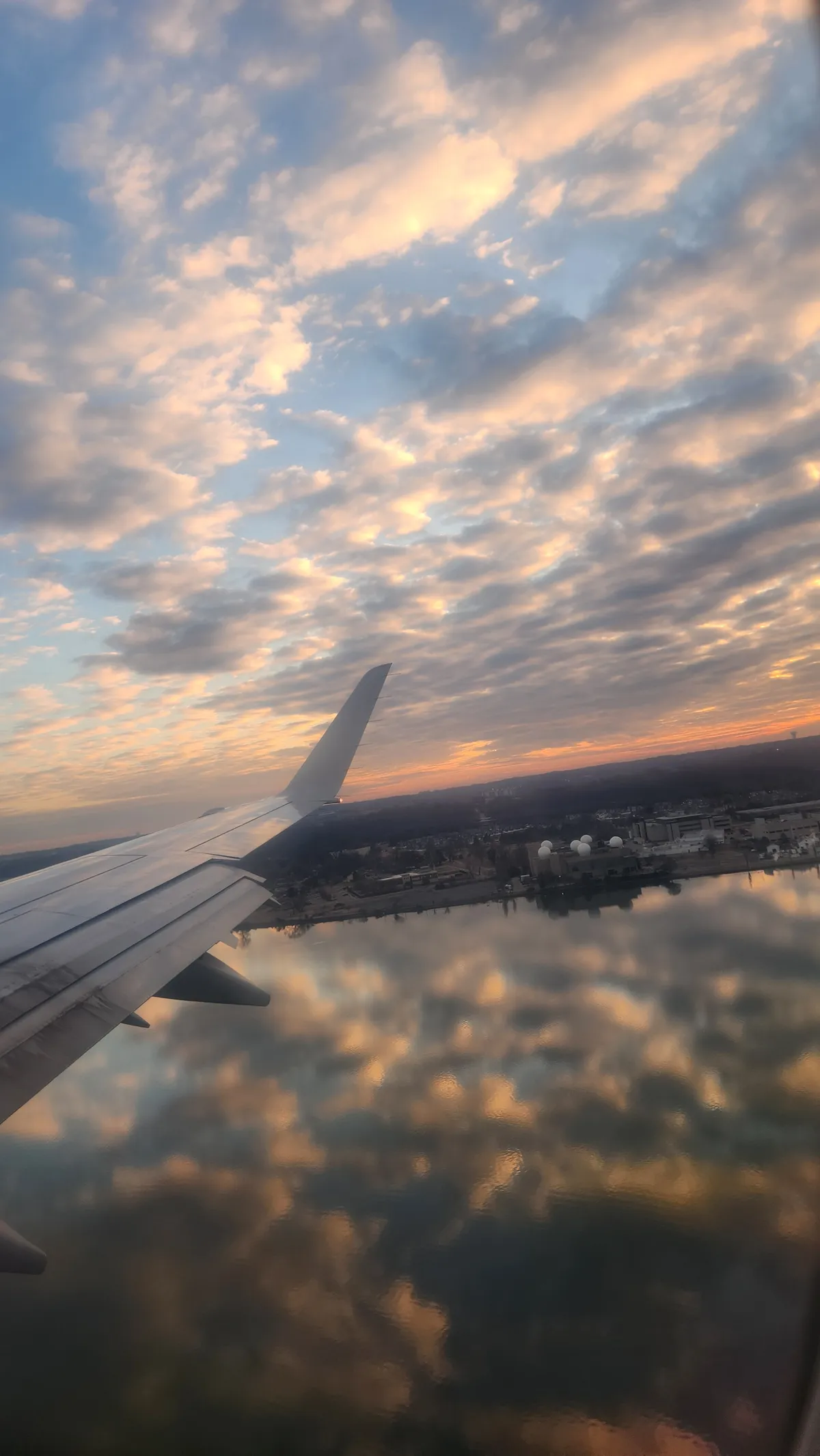 Sunset reflected on a river from above, view from airplane