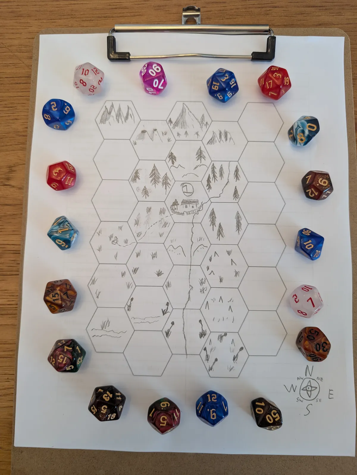 Picture of hexmap surrounded by dice of various color and sizes
