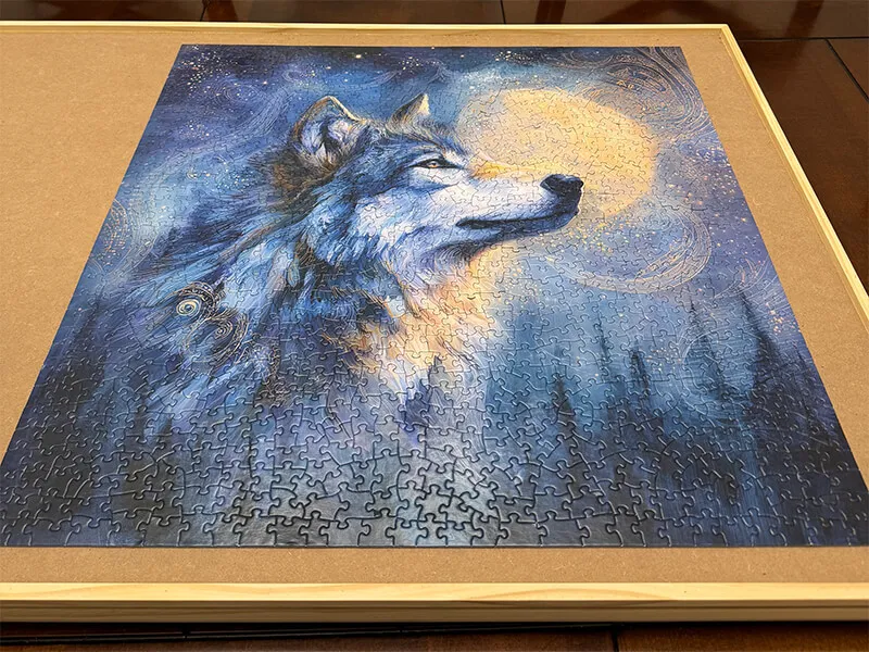 Jigsaw puzzle of a wolf head profile with moon behind it.