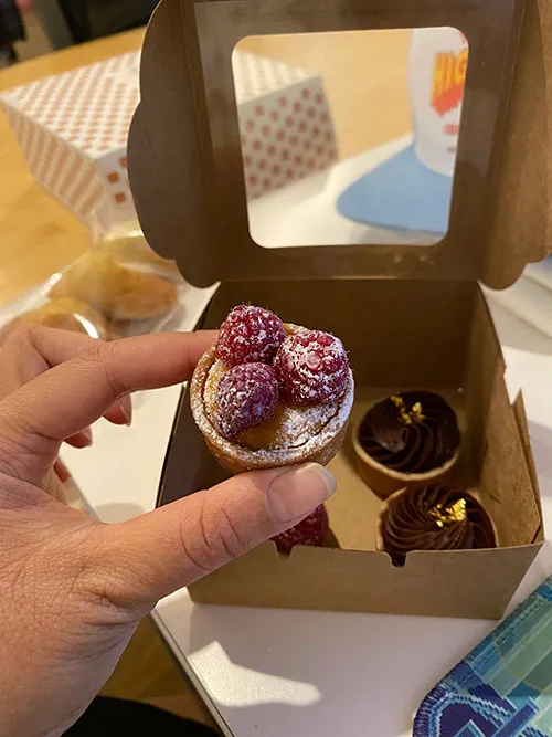 Hand holding a raspberry petit four