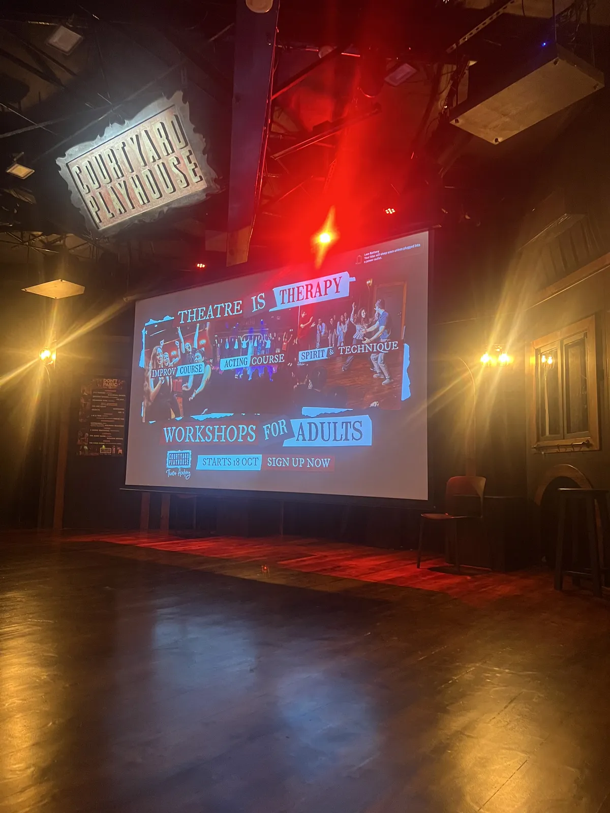 Big screen promoting improv workshops