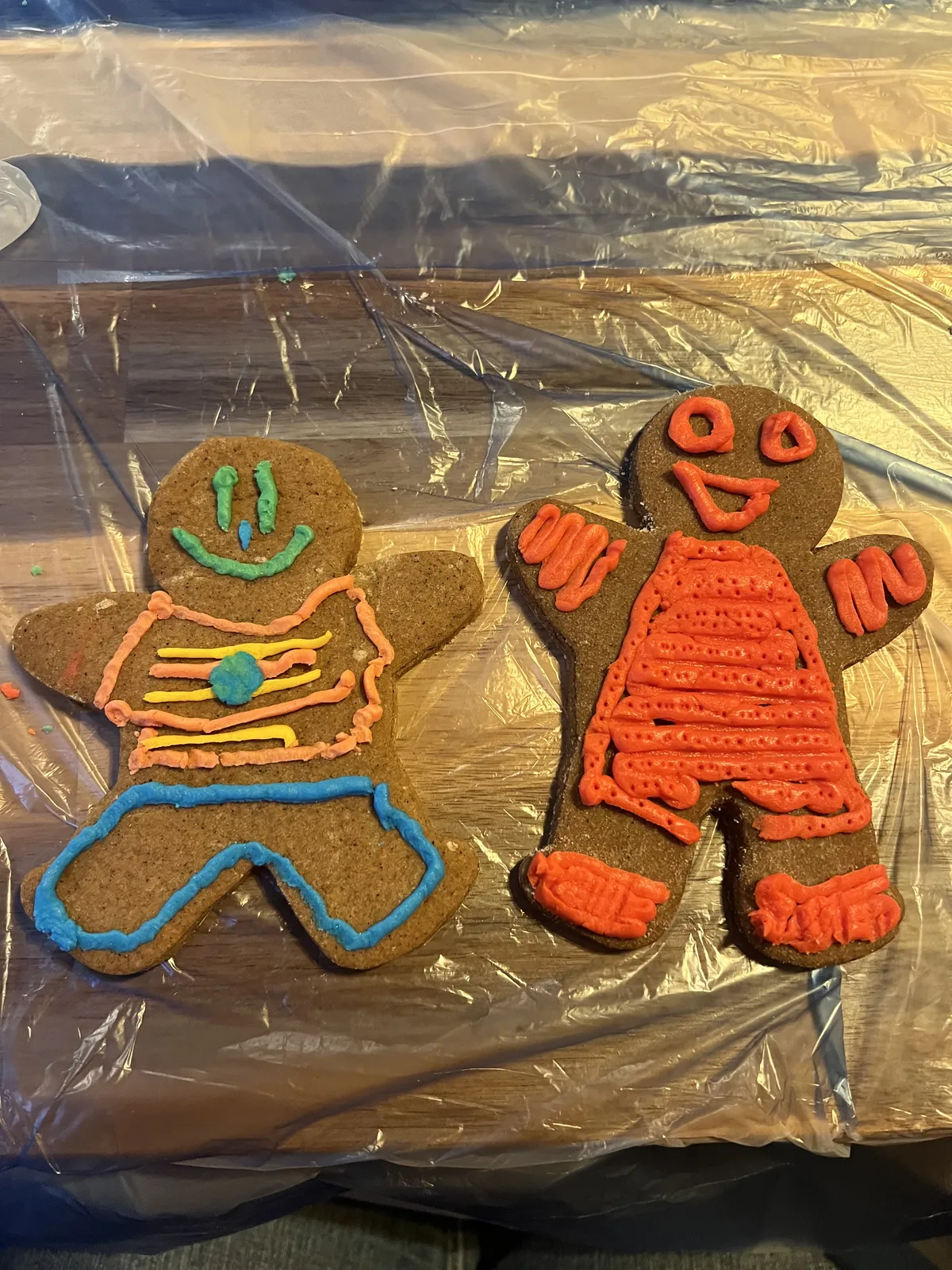 Smiling gingerbread cookies decorated with bright icing