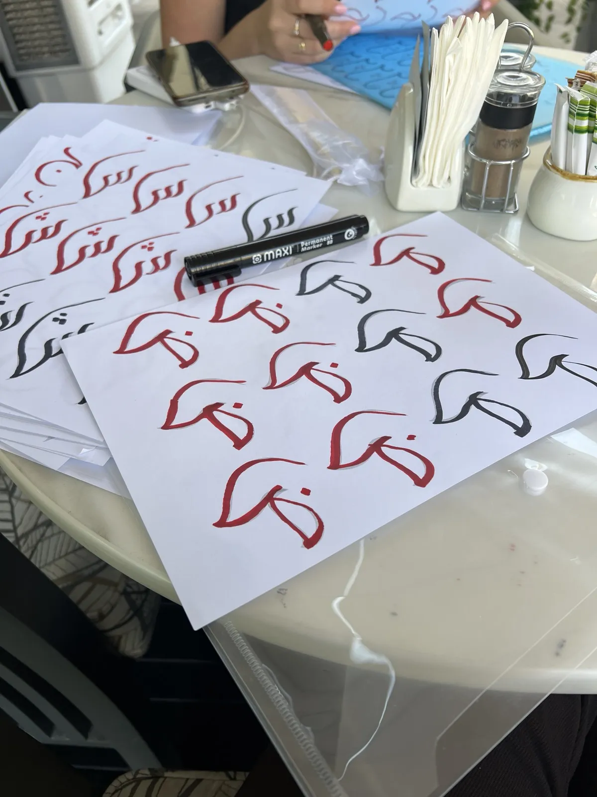 Tracing letters in an Arabic calligraphy class