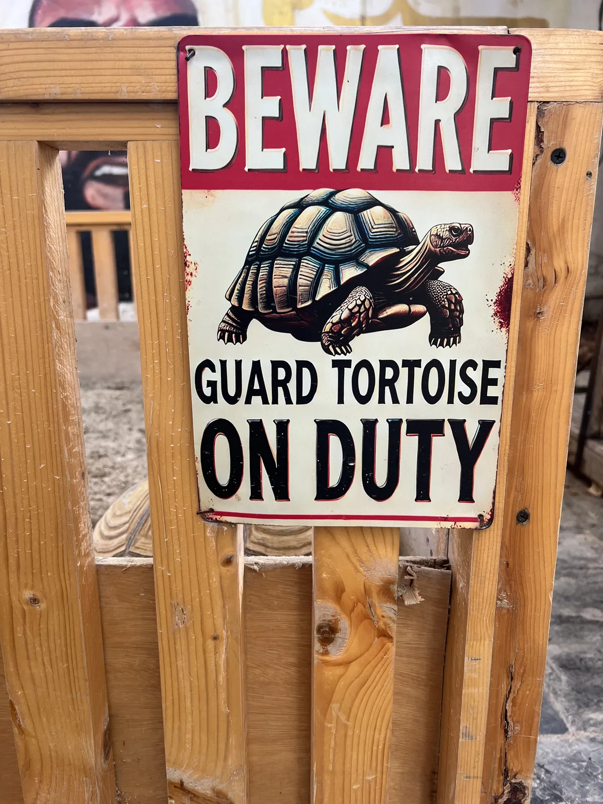 Sign reading 'Beware! Guard tortoise on duty'