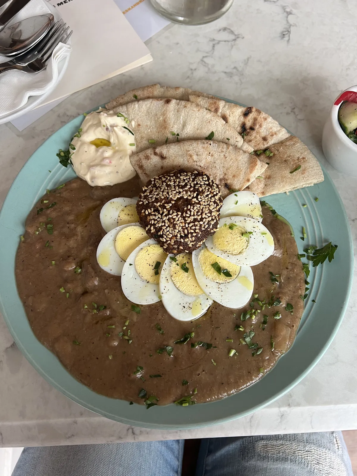 Egyptian breakfast of mashed beans (ful), boiled eggs, falafel and pita bread