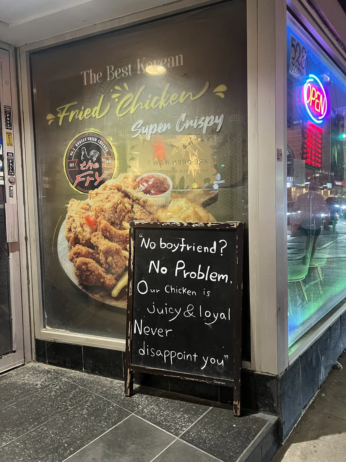 Sign outside a Korean restaurant reading 'No boyfriend? No problem. Our chicken is juice and loyal. Never disappoint you'