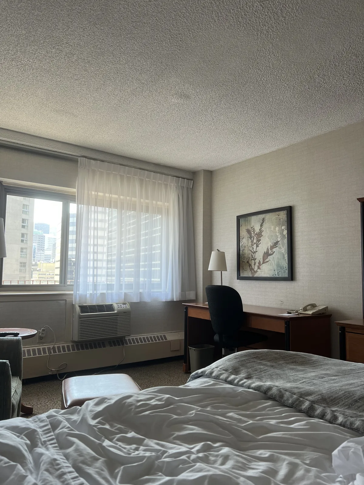 Hotel room with messy bed