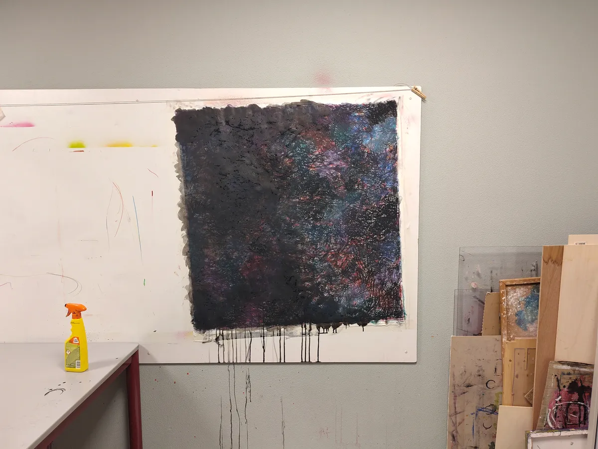 A drawing in oil crayon and india ink covering half a whiteboard