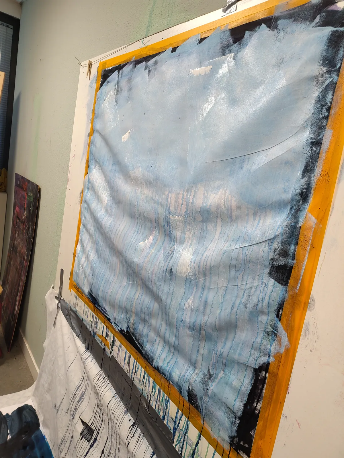 a painting covered in white acrylic